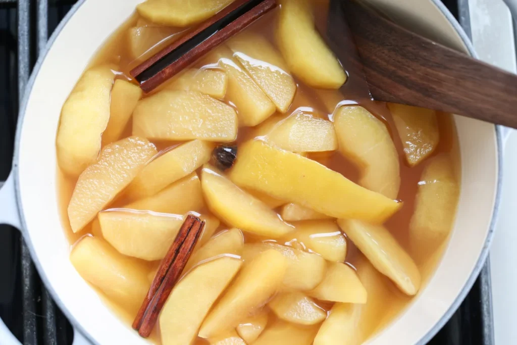Bowl of warm stewed apples with cinnamon and ginger