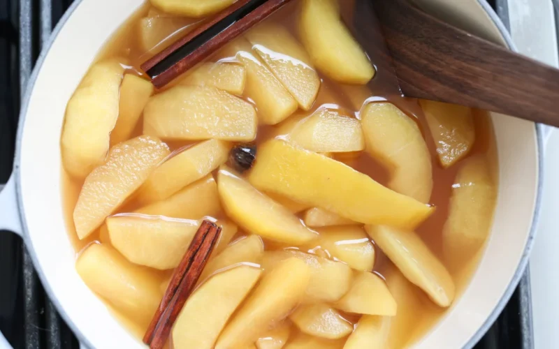 Bowl of warm stewed apples with cinnamon and ginger