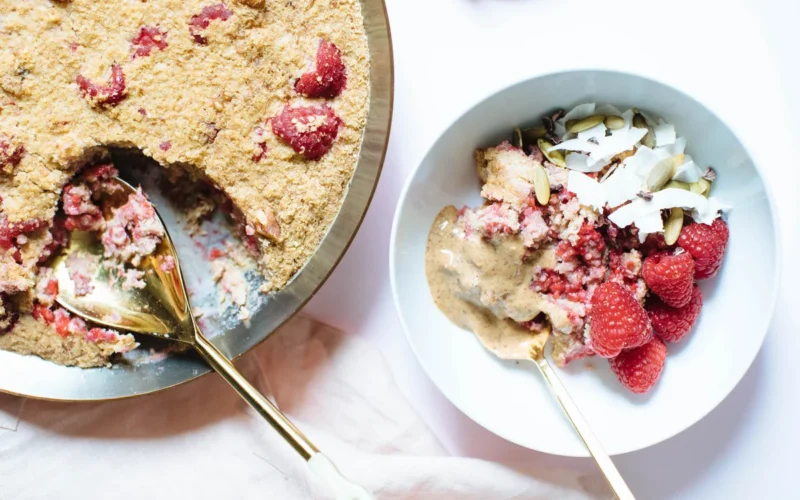 Baked raspberry porridge with fresh berries and oats