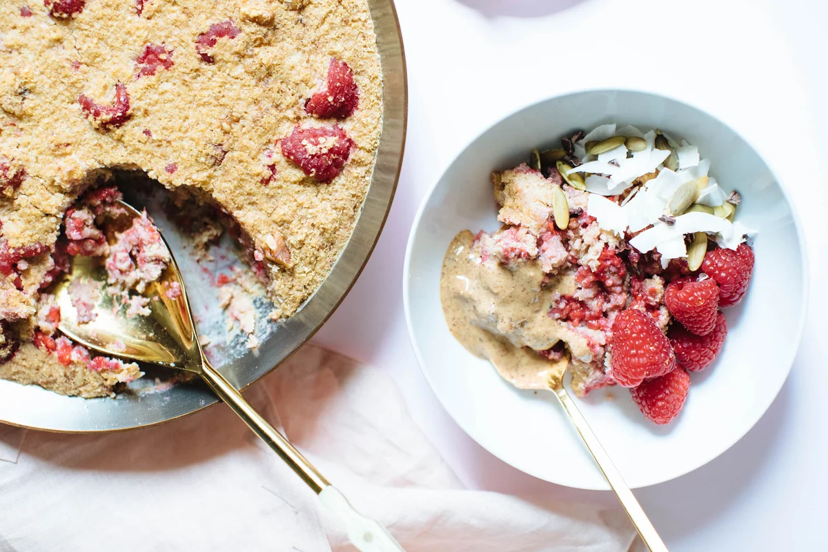 Baked raspberry porridge with fresh berries and oats