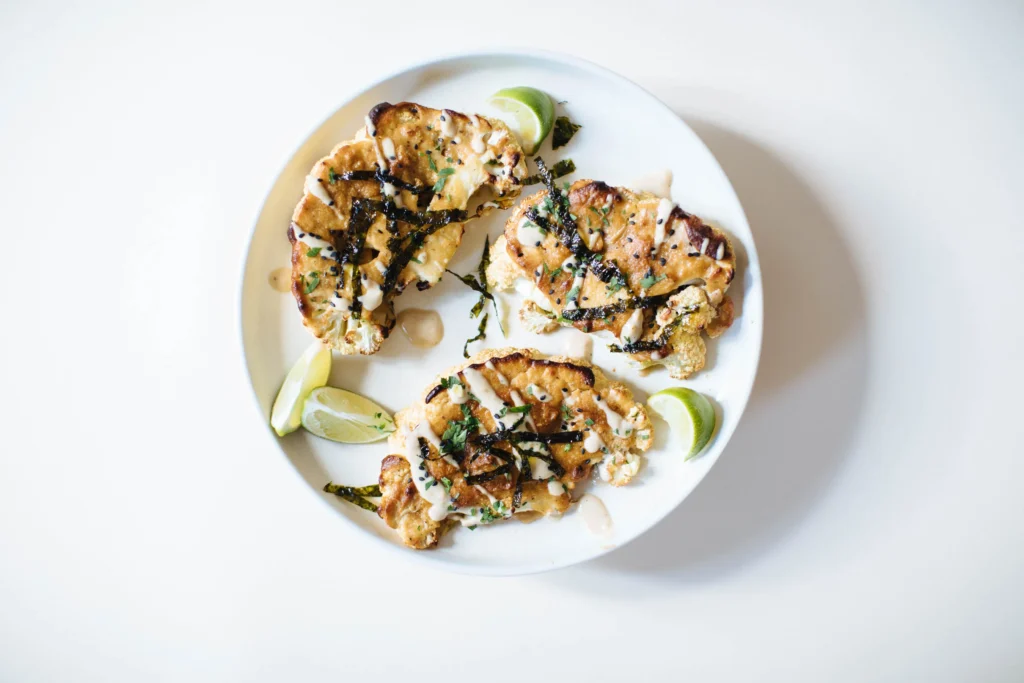 Tahini miso cauliflower steaks on a plate