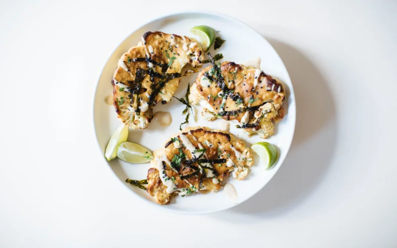 Tahini miso cauliflower steaks on a plate