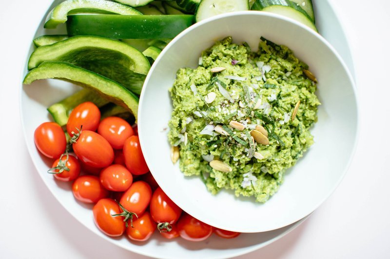 Close-up of blended pea and mint dip with fresh herbs