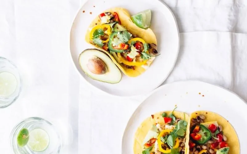 Colorful breakfast taco ingredients laid out on counter