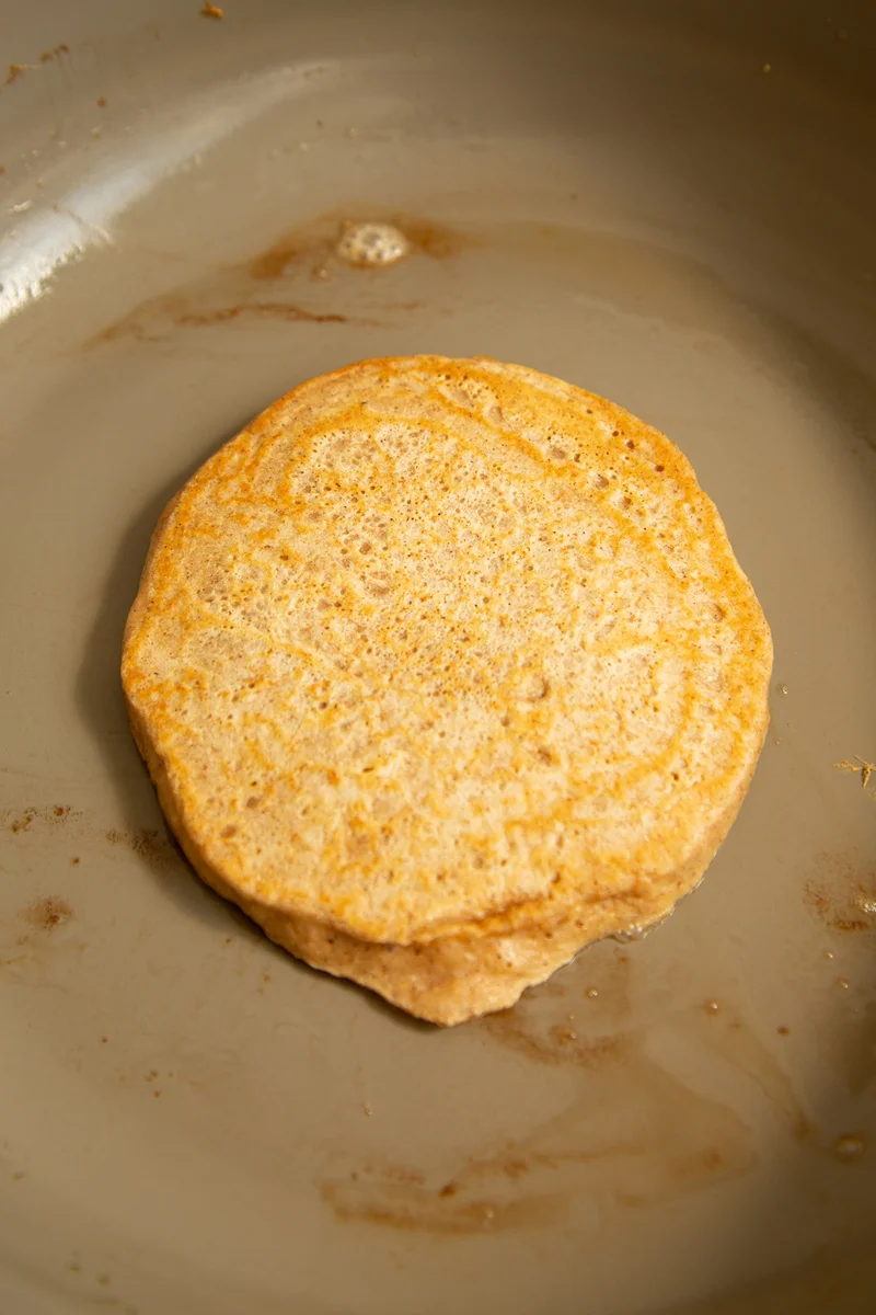 Pancake batter being poured into a heated skillet