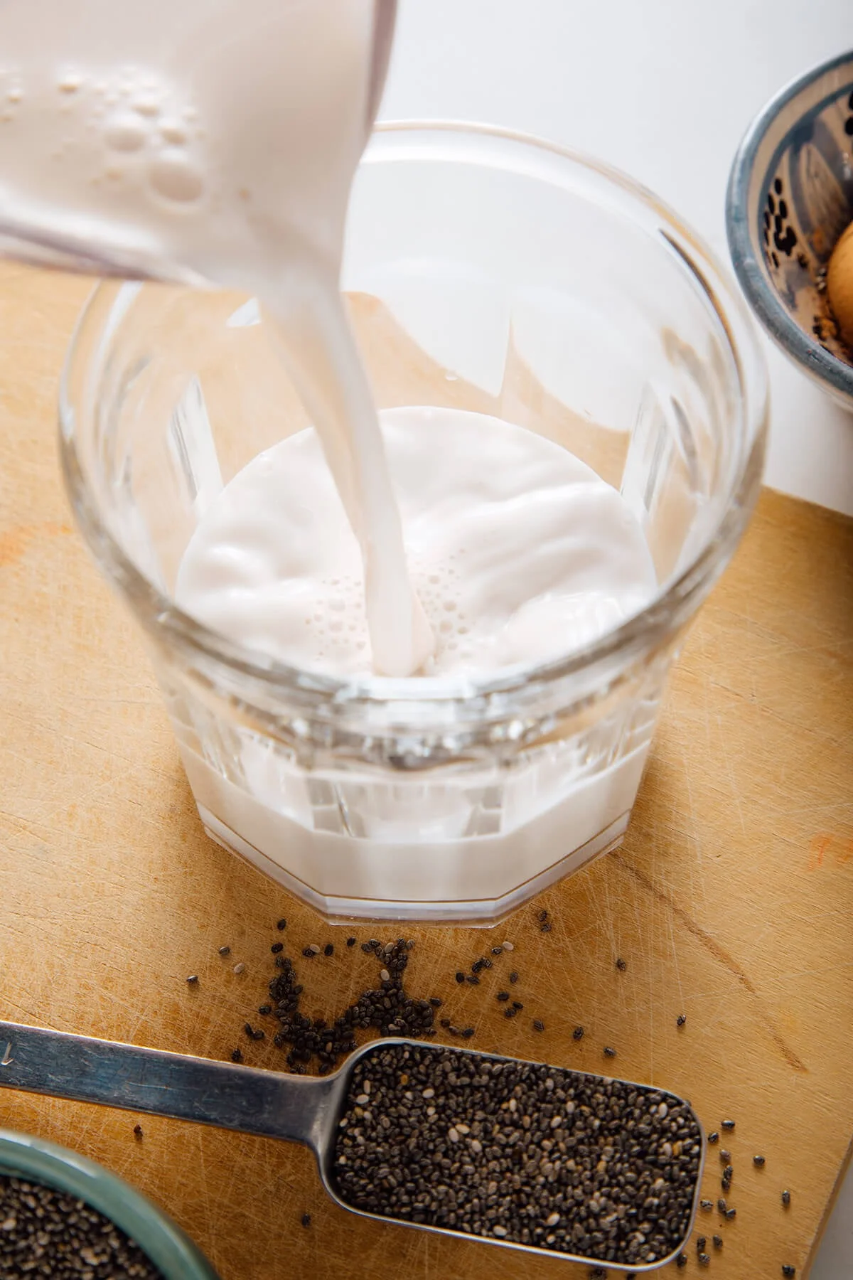 Pouring milk into a glass jar for pudding