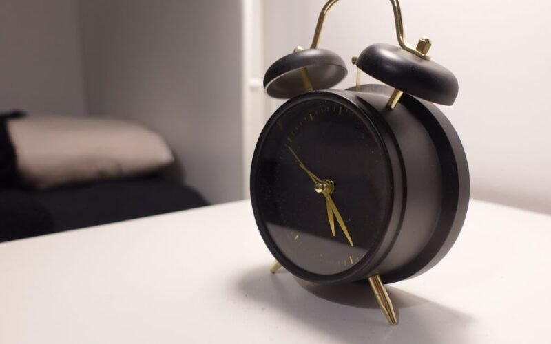 Alarm clock on a bedside table in a calm bedroom