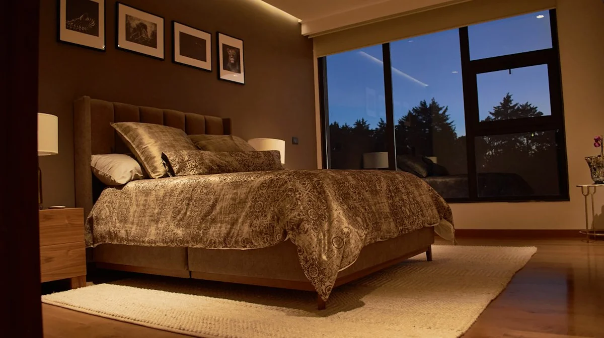 Calm, dimly lit bedroom at dusk ready for a restful night's sleep