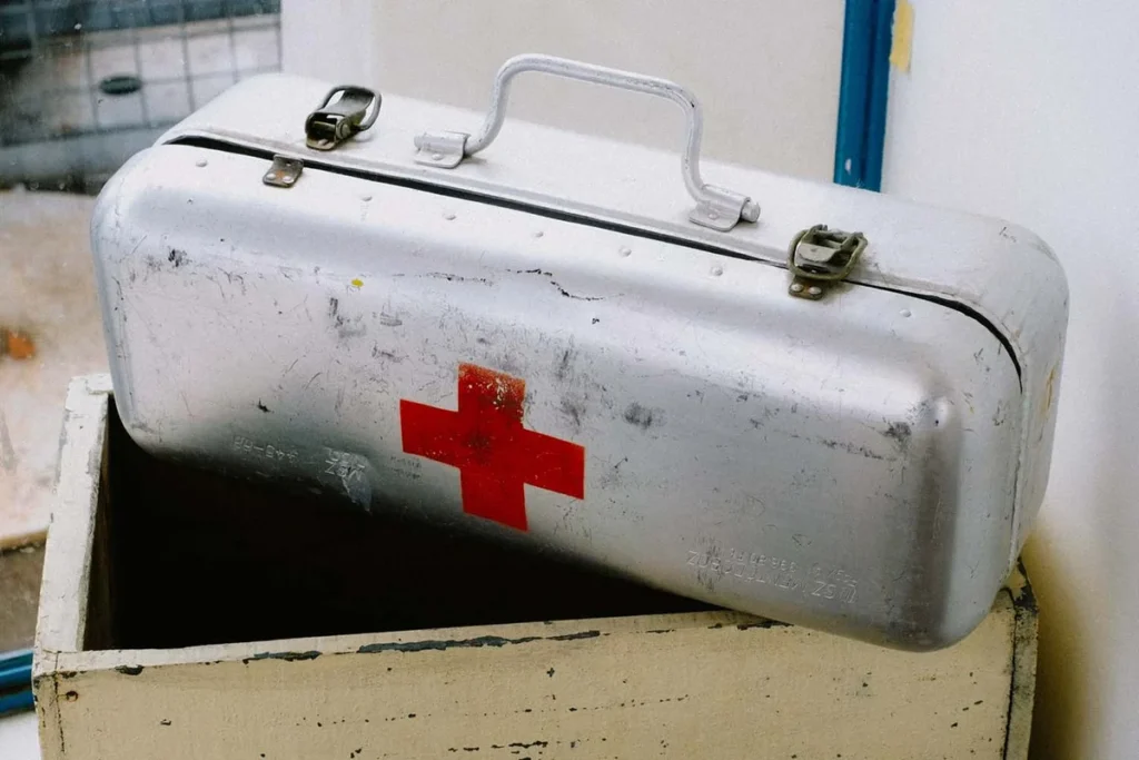 Open first aid kit with bandages and gauze pads visible