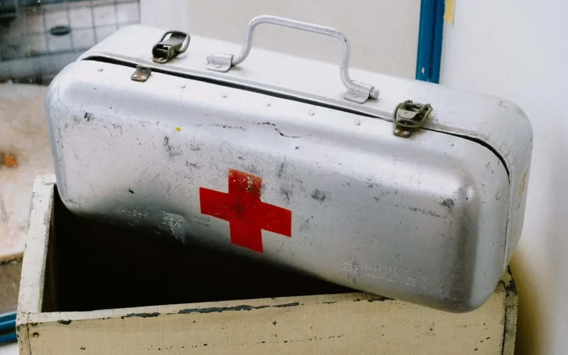 Open first aid kit with bandages and gauze pads visible