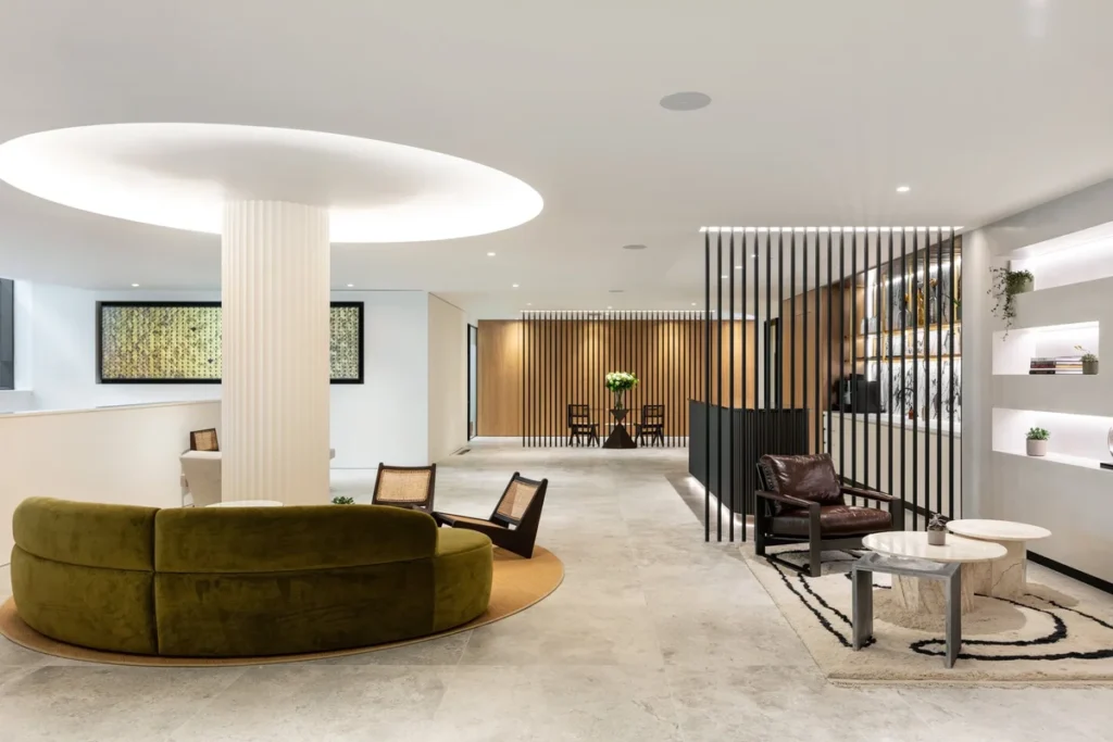 Modern clinic lounge with curved sofa and wooden slat partitions