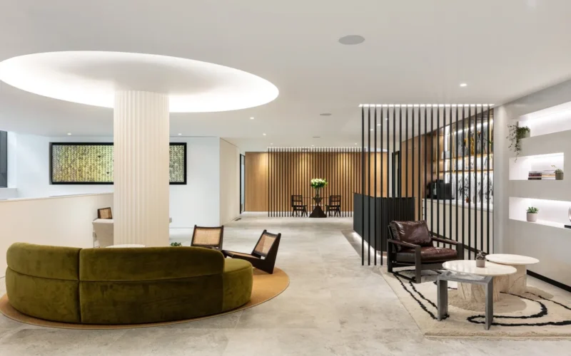Modern clinic lounge with curved sofa and wooden slat partitions