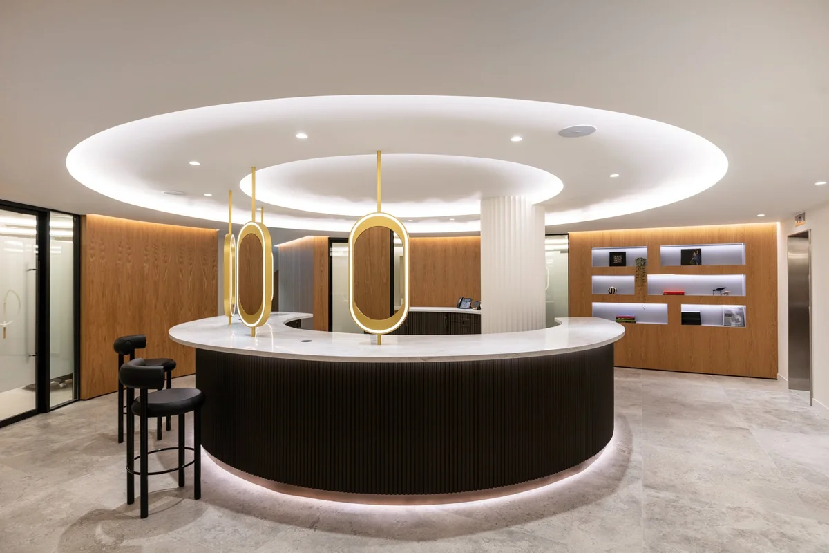 Modern clinic reception desk with gold oval light fixtures